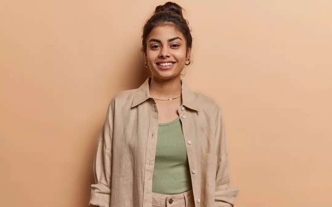 woman smiling against wall